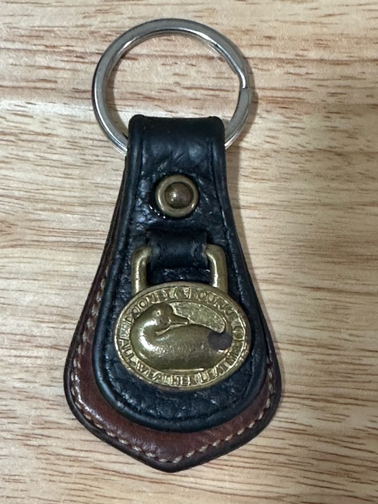 Dooney & Bourke Other - Dooney & Bourke Black and Brown Leather Key Fob with Brass Oval Logo